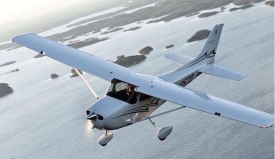Cessna 172 over water.