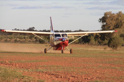 If it is red earth look out for greener patches that can hide mud or water. Country Airstrips Australia.